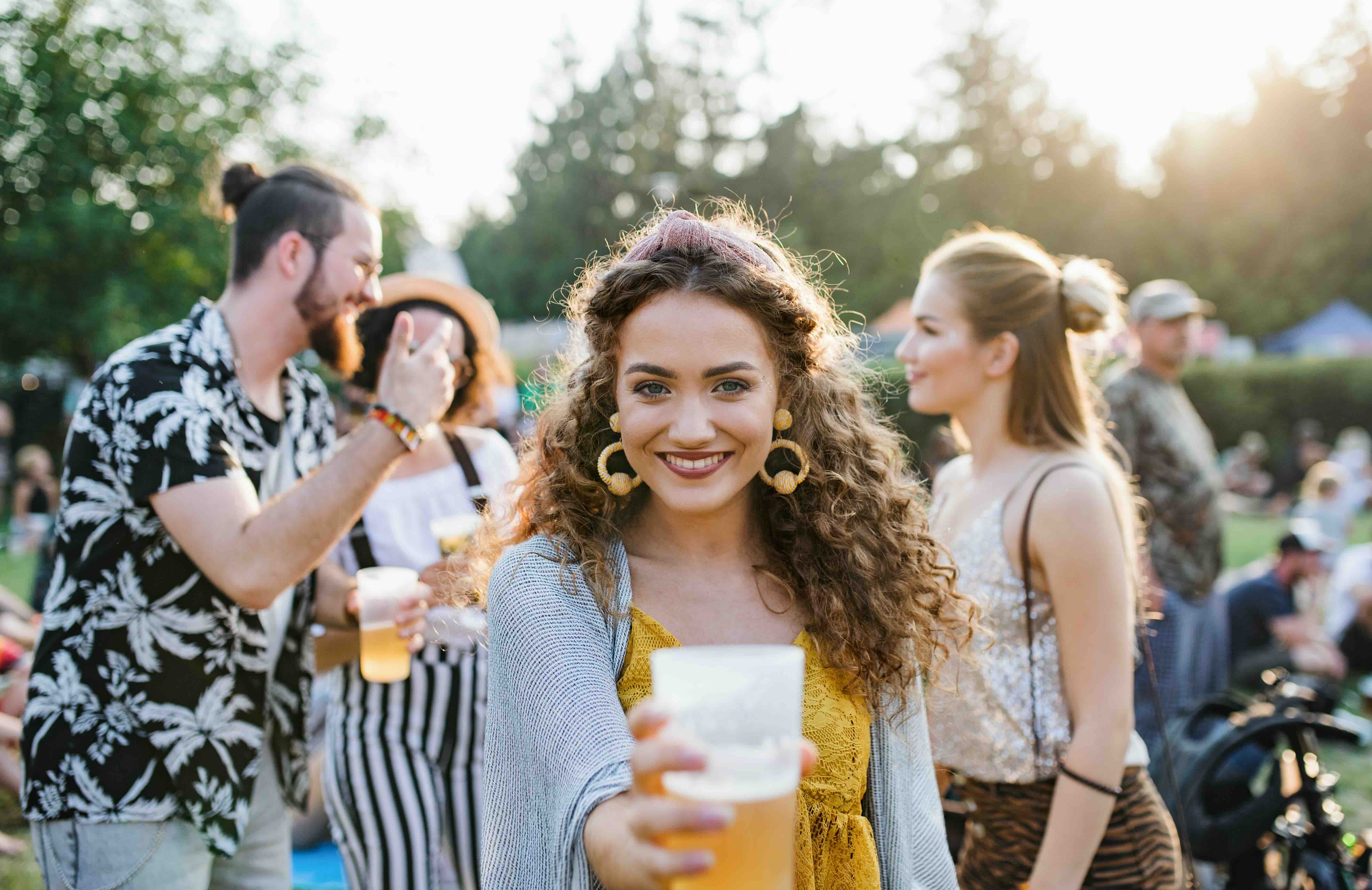 Girl drinking a beer at a nice event